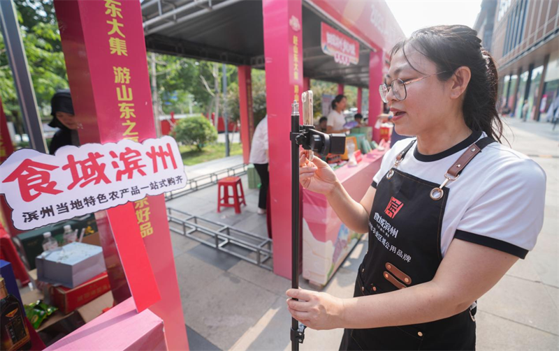 6月28日，在山東省鄒平市的夏季“黃河大集”田園豐收市集，來自濱州的美食博主在現(xiàn)場(chǎng)直播。